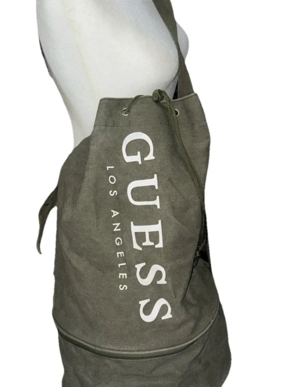 GUESS Olive Canvas Drawstring Sling Duffel Bag with zipper bottom.